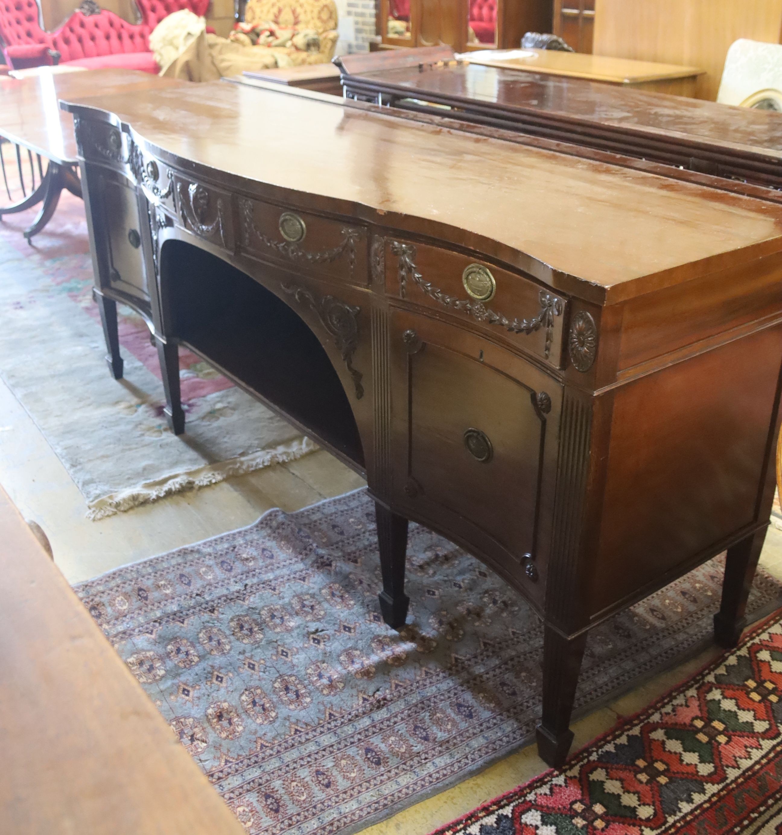 An early 20th century Adam design mahogany serpentine sideboard, length 214cm, depth 68cm, height 92cm